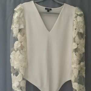 Express bodysuit with mesh floral lace puff sleeves.